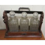 An early 20thC oak and silver plated tantalus with three decanters  10"h  14"w