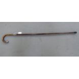 A late Victorian ladies walking cane with a crook handle, engraved silver ferrule and cap