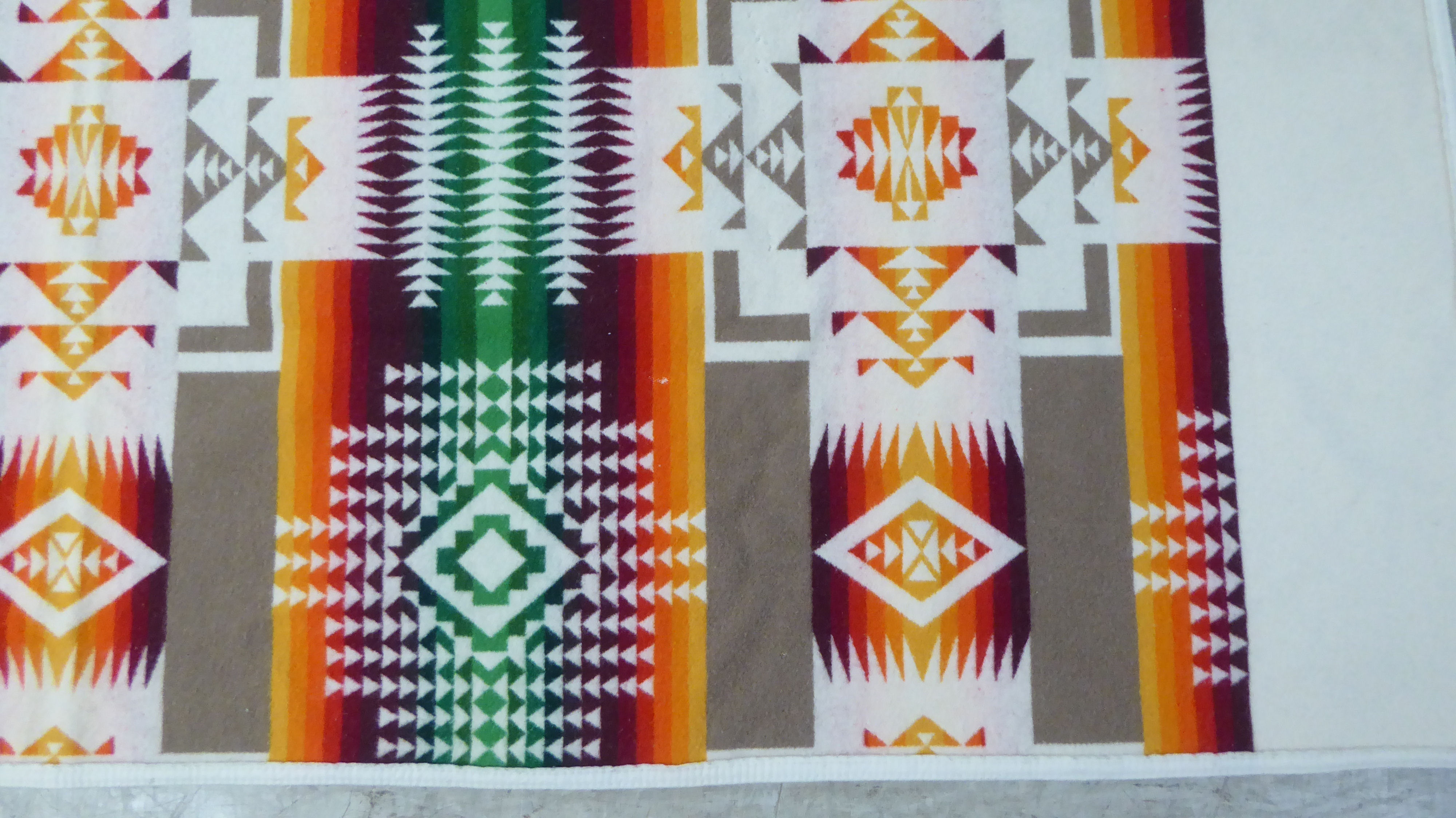A Beaver State woollen throw/rug, highly decorated in orange and brown tones, on a cream coloured - Image 2 of 5