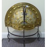 A late 19thC Arts & Crafts brass firescreen, raised on wrought iron legs  25"h  22"w