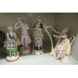 Four late 19th/early 20thC European porcelain figures: to include a woman playing a harp  7"h