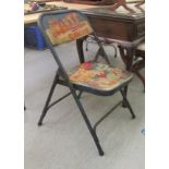 A cast metal folding chair, painted with a scene depicting Billy Smarts Circus