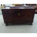 A 19thC rosewood tea casket of sarcophagus form with opposing ring handles, the hinged lid enclosing