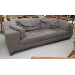 A modern Chesterfield inspired box settee with a low back and integral arms, upholstered in