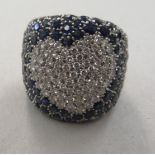 An 18ct white gold pave set diamond and sapphire heart design ring