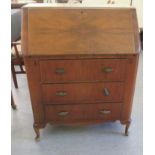 An Art Deco walnut bureau with a fall flap, over three drawers, raised on stubby cabriole legs  39"h