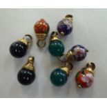 A set of eight spherical, variously coloured stone pendant, suspended in identical 9ct gold ring