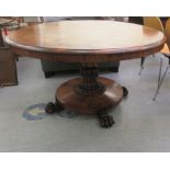A William IV rosewood breakfast table with a circular tip-top and a carved column, raised on lion
