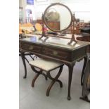 An Edwardian mahogany two drawer dressing table with a separate mirror, raised on cabriole legs