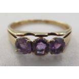 A 14ct gold three stone amethyst ring