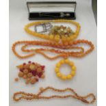 Items of personal ornament: to include amber coloured bead necklaces; and a decoratively cast