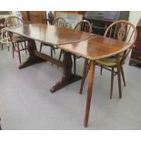 A modern Ercol stained beech dining table, raised on trestle ends and platform feet  28"h  59"L