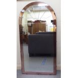 An Art Deco mirror with tinted bronze highlights and a segmented, arched top  40" x 20"