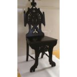 A 19thC stained oak framed hall chair, carved in Islamic taste with arabesques, the solid seat