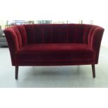 A modern Art Deco inspired Orior two person settee, the concave shell design, red fabric upholstered