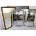 Three dissimilar modern bevelled, framed mirrors: to include one with subdivided into nine equal