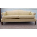 A modern Orior three person settee with an arched back and level, enclosed arms, upholstered in