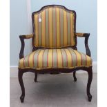 A modern Louis XV style stained beech framed, open arm salon chair, upholstered in striped patterned