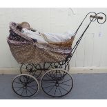 A mid 20thC Victorian design dolls pram with a woven split cane basket top, on spoked wheels; and