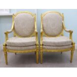 A pair of modern Louis XVI style antique finished gilded showwood framed salon chairs, upholstered