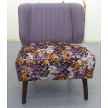 A modern Orior bedroom chair, upholstered in lilac coloured and floral patterned fabric with a