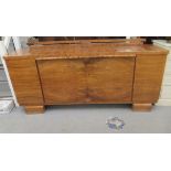 An Art Deco walnut veneered sideboard, the top having a low, galleried upstand and round corners,