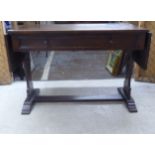 A 1920s stained oak single drawer sofa table, raised on planked ends, united by a stretcher  29"h