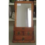 A 20thC Chinese fruitwood effect vanity box, the hinged lid revealing an angled mirror, over two