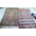 A shaggy North African design rug, decorated in bright colours  44" x 78"; and a Persian rug, on a