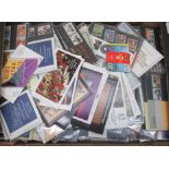 Uncollated, unused presentation packs of postage stamps