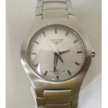 A stainless steel cased and strapped Longines wristwatch, faced by a baton dial with a date