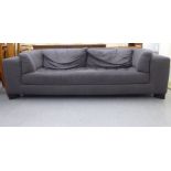 A modern box settee with a low back and integral arms, upholstered in cushioned charcoal coloured