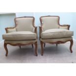 A pair of modern Louis XV inspired, stained beech framed  enclosed armchairs, upholstered in biscuit