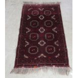 A Bokhara rug, decorated with scattered guls on a red ground  34" x 56"