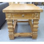 A modern fruitwood coffee table with a frieze drawer, raised on carved block legs  24"h  32"w