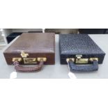 Two similar modern faux snakeskin jewellery cases with brass fittings  12"w