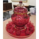 A Continental gilded cranberry glass punch set  comprising a melon shaped tureen, cover and a tray