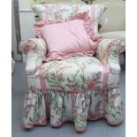 An Edwardian floral fabric upholstered bedroom chair, raised on square legs with casters