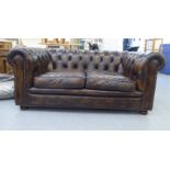 A modern two person Chesterfield, button upholstered in faux brown hide   63"w