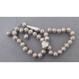 A string of white metal Muslim prayer beads