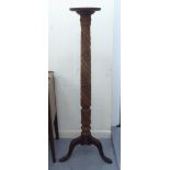 An early 20thC floral carved mahogany torchere, on a splayed tripod base  54"h