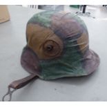 A German Great War military steel camouflage helmet with a liner and chinstrap (Please Note: this