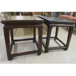 A pair of early 20thC Chinese fruitwood side tables, each with a mitred top, raised on tapered legs