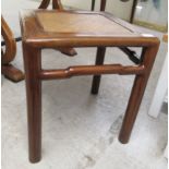 A 20thC Chinese fruitwood occasional table, the top with a cane panel, raised on turned legs  18"