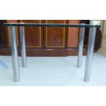 A modern glass top hall table, raised on tubular chromium plated legs  29"h  42"w