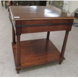 A late 19thC mahogany single drawer, two tier lamp table, raised on pillar supports  22"h  22"w