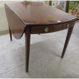 An Edwardian mahogany Pembroke table with a frieze drawer, raised on square, tapered legs  29"h