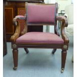 A modern Regency style mahogany framed open arm chair with a maroon fabric upholstered back and