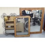 Three variously sized and framed mirrors