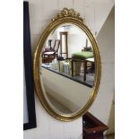 A modern mirror, the oval plate set in a moulded gilt frame  33" x 22"